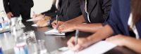 Group of business executives taking notes